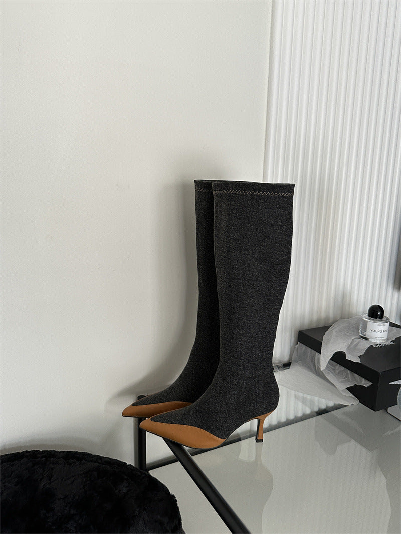 Charcoal knit knee-high boots with tan pointed toes and thin heels.