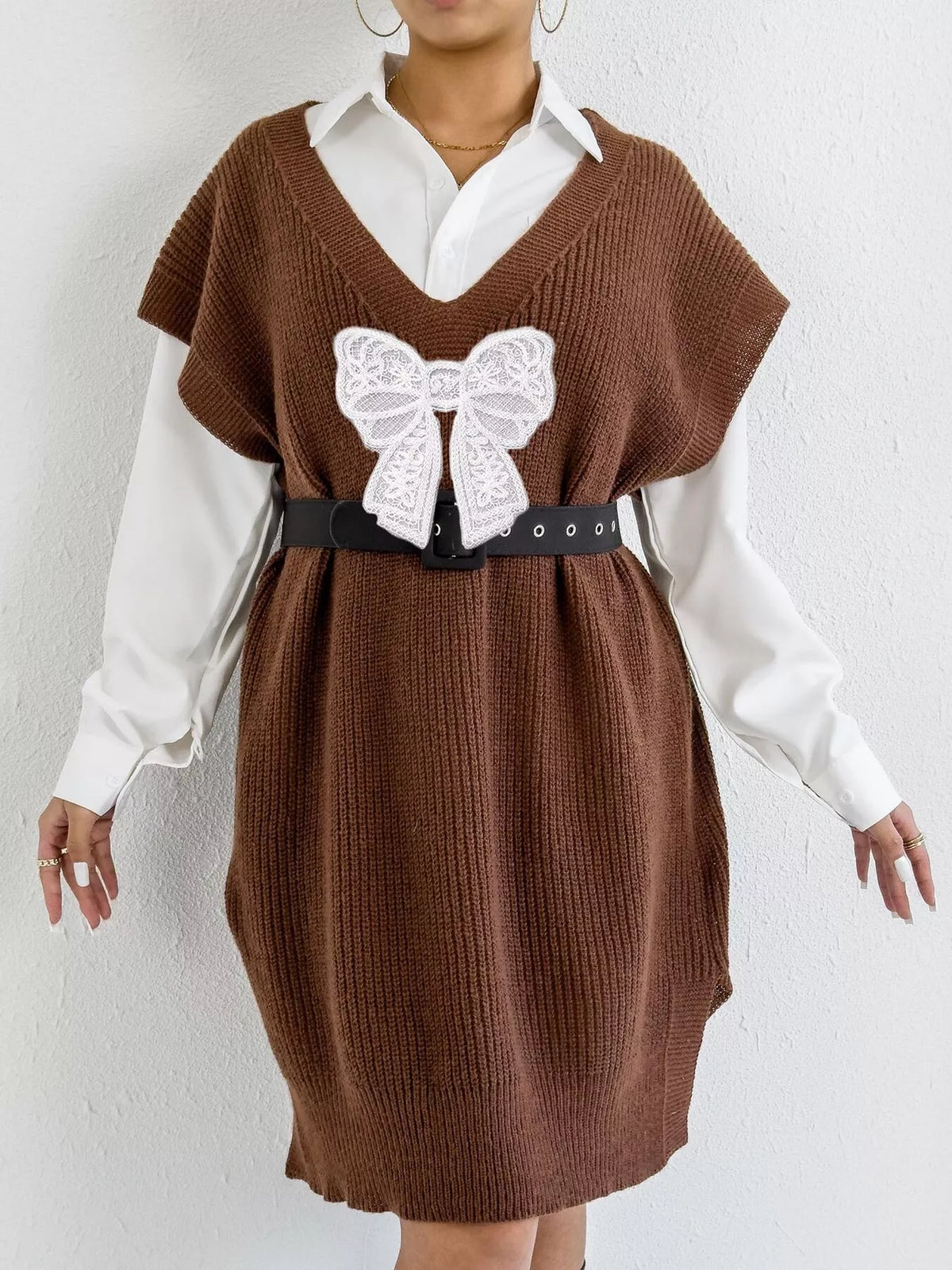 Embroidered bow V-neck sweater vest by Trendsi, featuring intricate embroidery and a classic V-neck design.