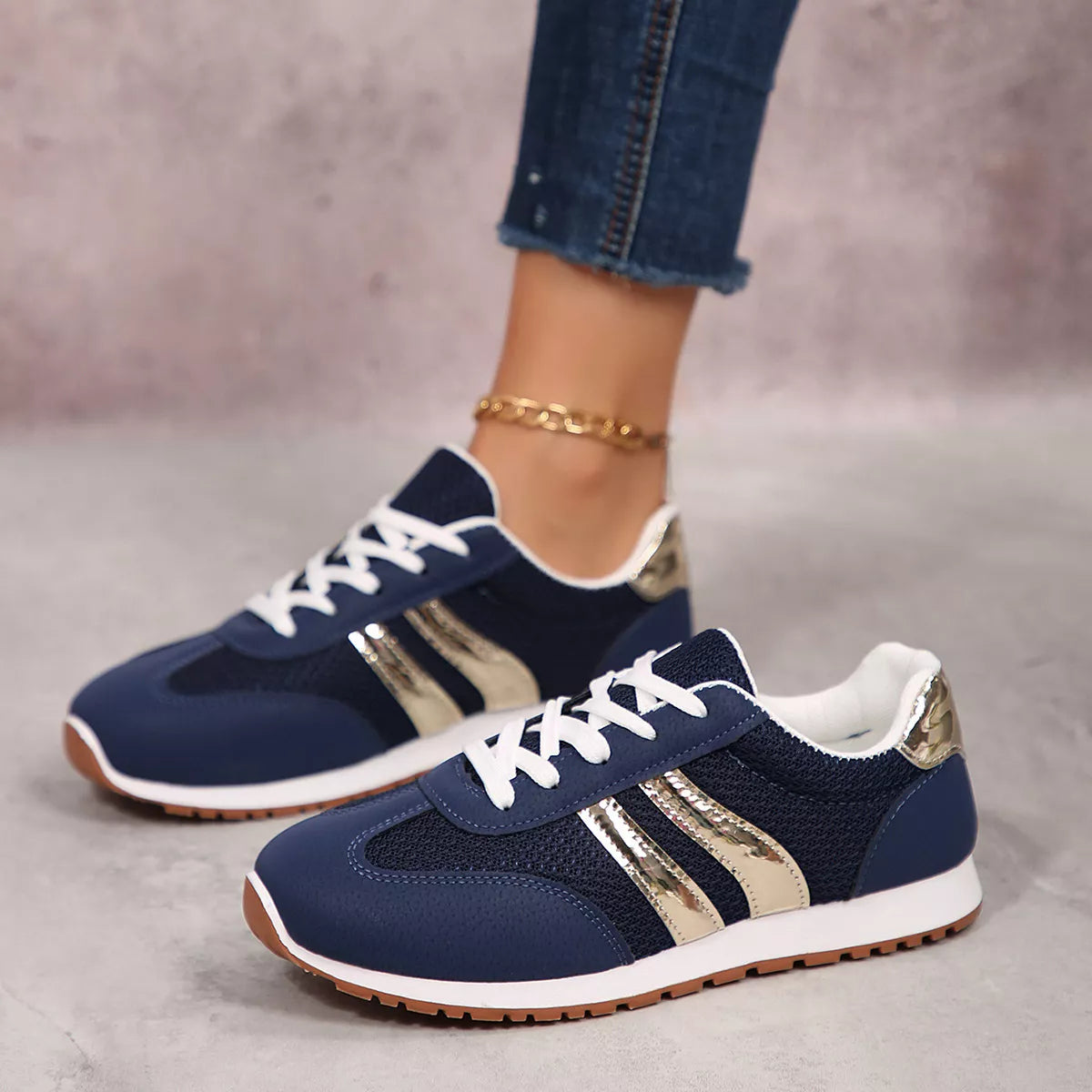 Women's round toe lace-up sneakers by Trendsi, featuring a classic design and white laces on a clean sneaker with a rubber sole.