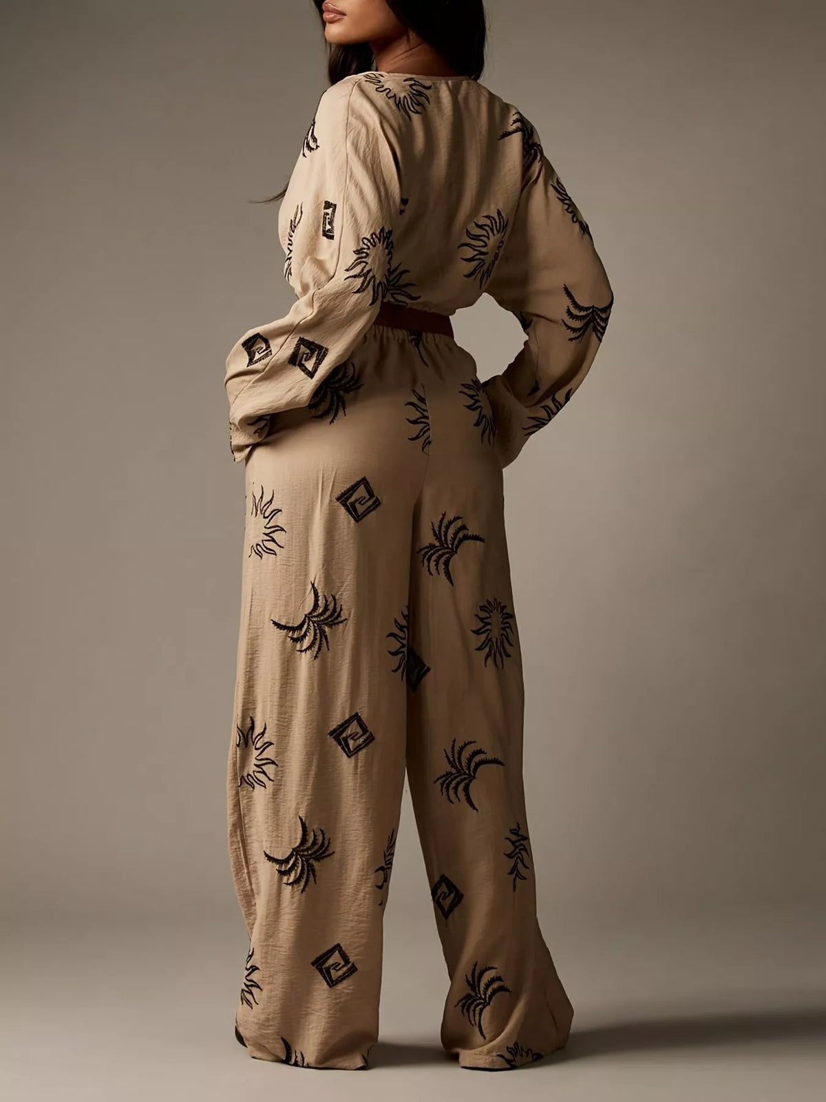 Printed crop top and wide-leg pants set for women by Trendsi, featuring stylish matching top and trousers in vibrant print.