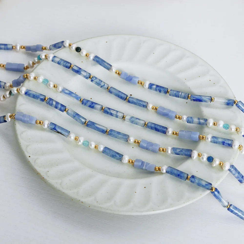 Freshwater pearl and titanium steel geometric bead necklace featuring modern design, stylish jewelry piece with elegant white pearls.