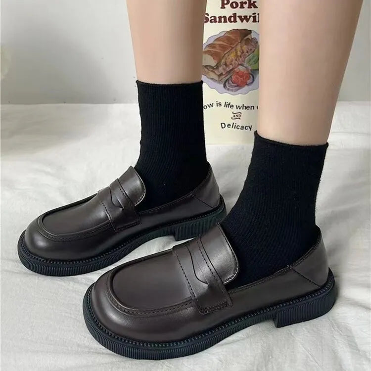 Women's leather loafers with round toes from Trendsi, showcasing classic slip-on design and smooth brown leather upper.