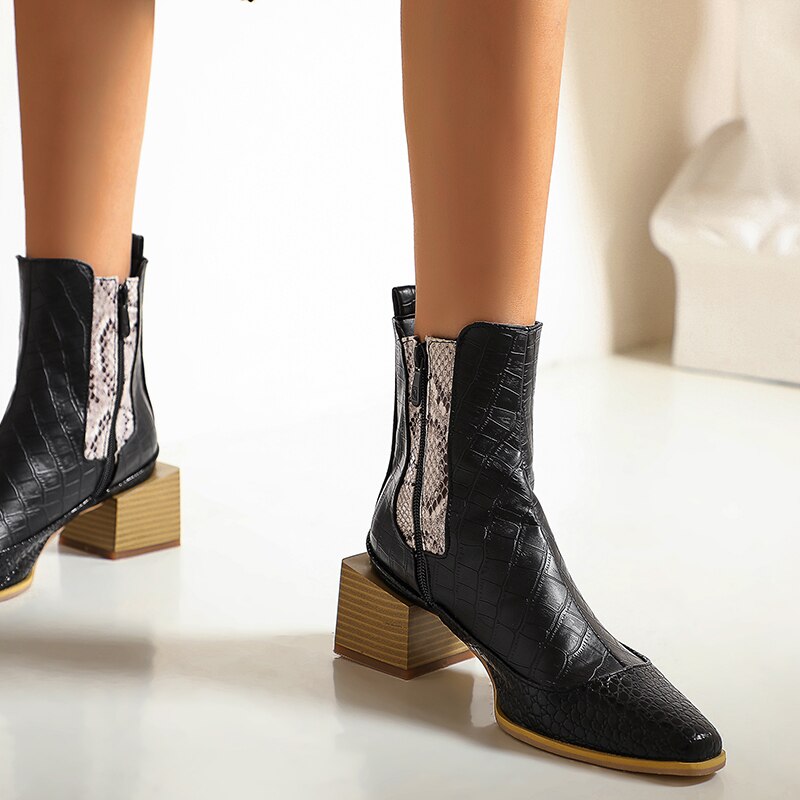 Black faux leather ankle boots with snake-print side panels, square block heels, and side zippers.