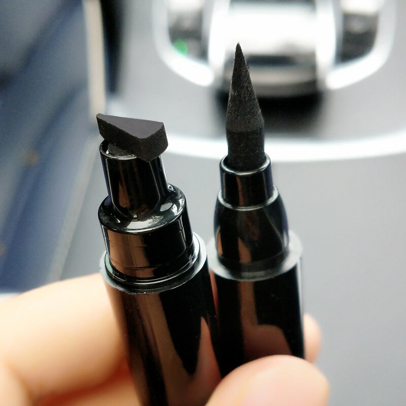 Two black plastic eyeliner pens, one with a stamp tip and one with a fine brush tip.