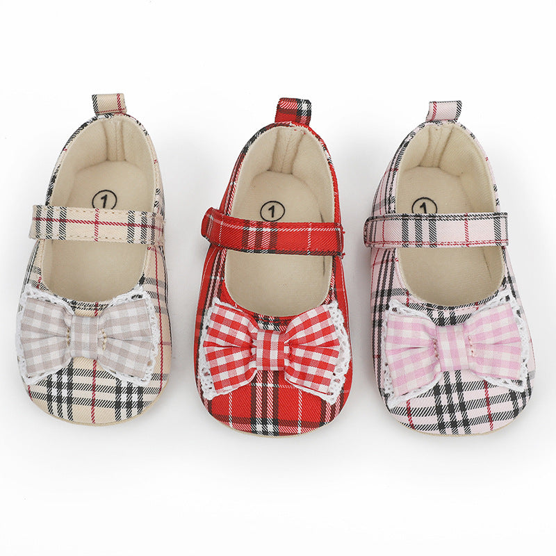 Three pairs of baby plaid canvas Mary Jane shoes in beige, red, and pink, with matching bows.