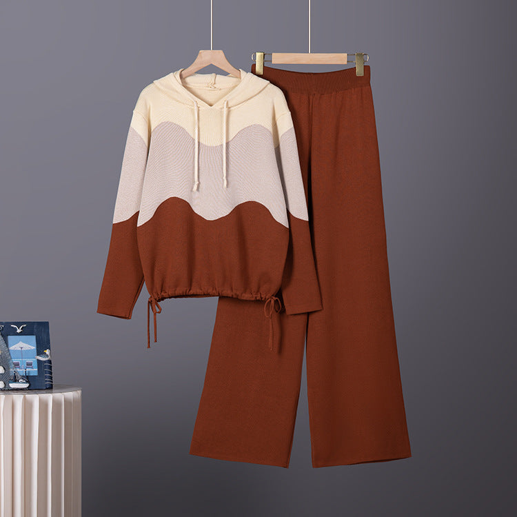 Brown, beige, and grey knit lounge set with a color-blocked hoodie and matching wide-leg pants on hangers.