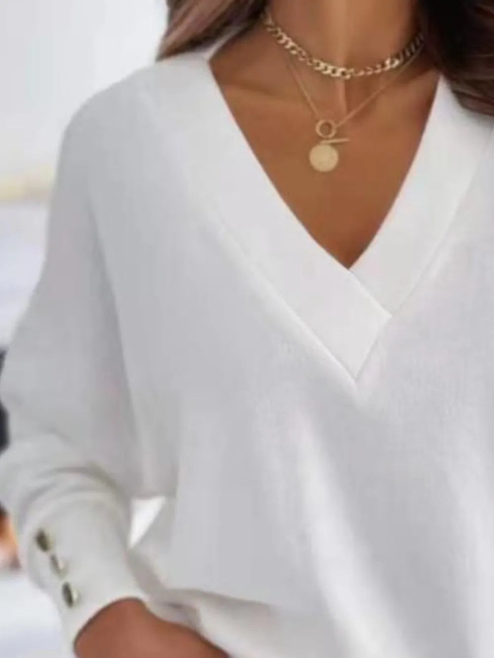 Gray V-neck long sleeve sweatshirt from Trendsi with a relaxed fit and soft fabric, displayed on a hanger.