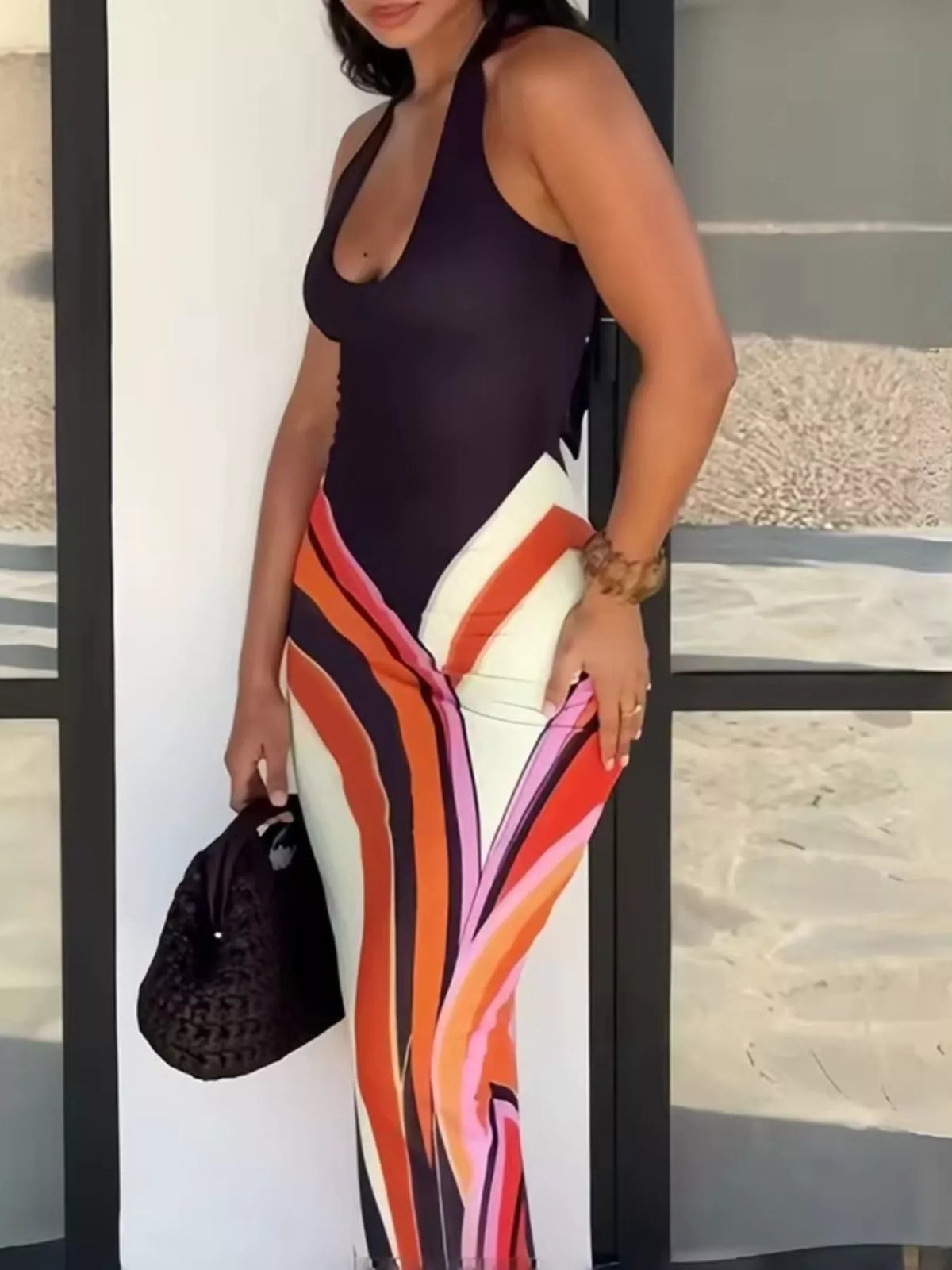 Plush Fashion Hub halter neck maxi dress with abstract print, flowing fabric, and sleeveless design for elegant summer wear.