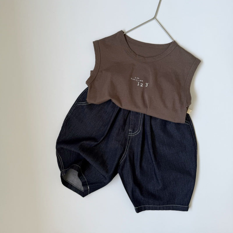 Brown cotton sleeveless top with white text and dark denim shorts with contrasting white stitching.