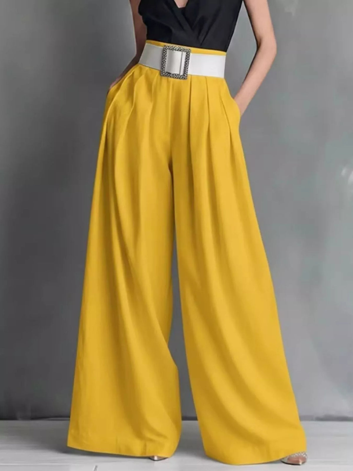 High-waisted wide-leg pants from Plush Fashion Hub, beige color, styled on a model, showcasing relaxed fit and flowy fabric.