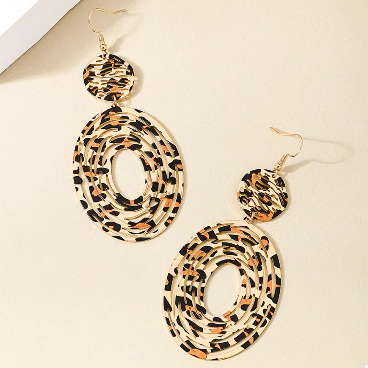 Leopard print dangle earrings from Plush Fashion Hub featuring gold hooks and bold animal print design.
