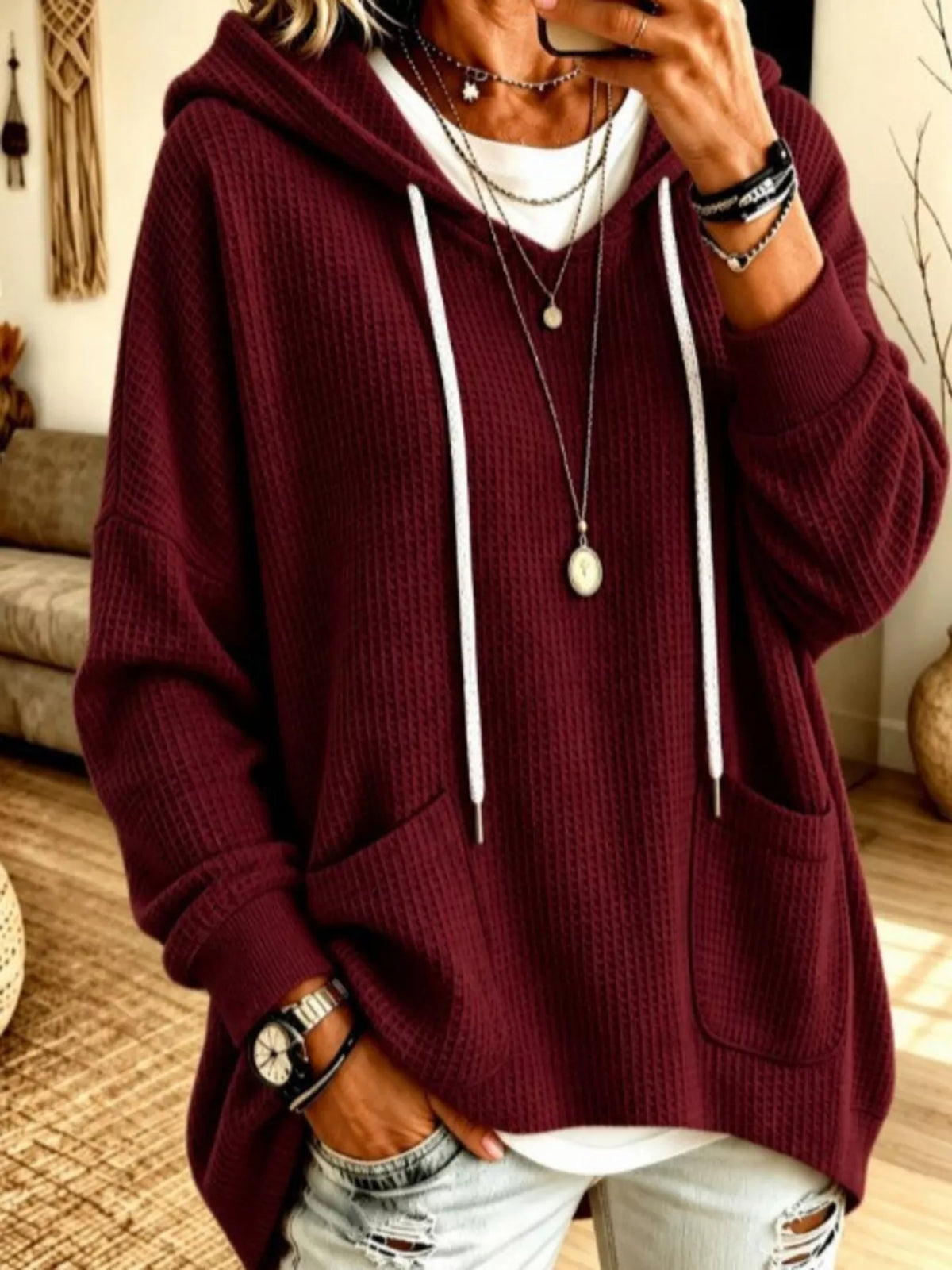 Plus size women's waffle knit hoodie with front pockets, casual and comfortable, by Trendsi.
