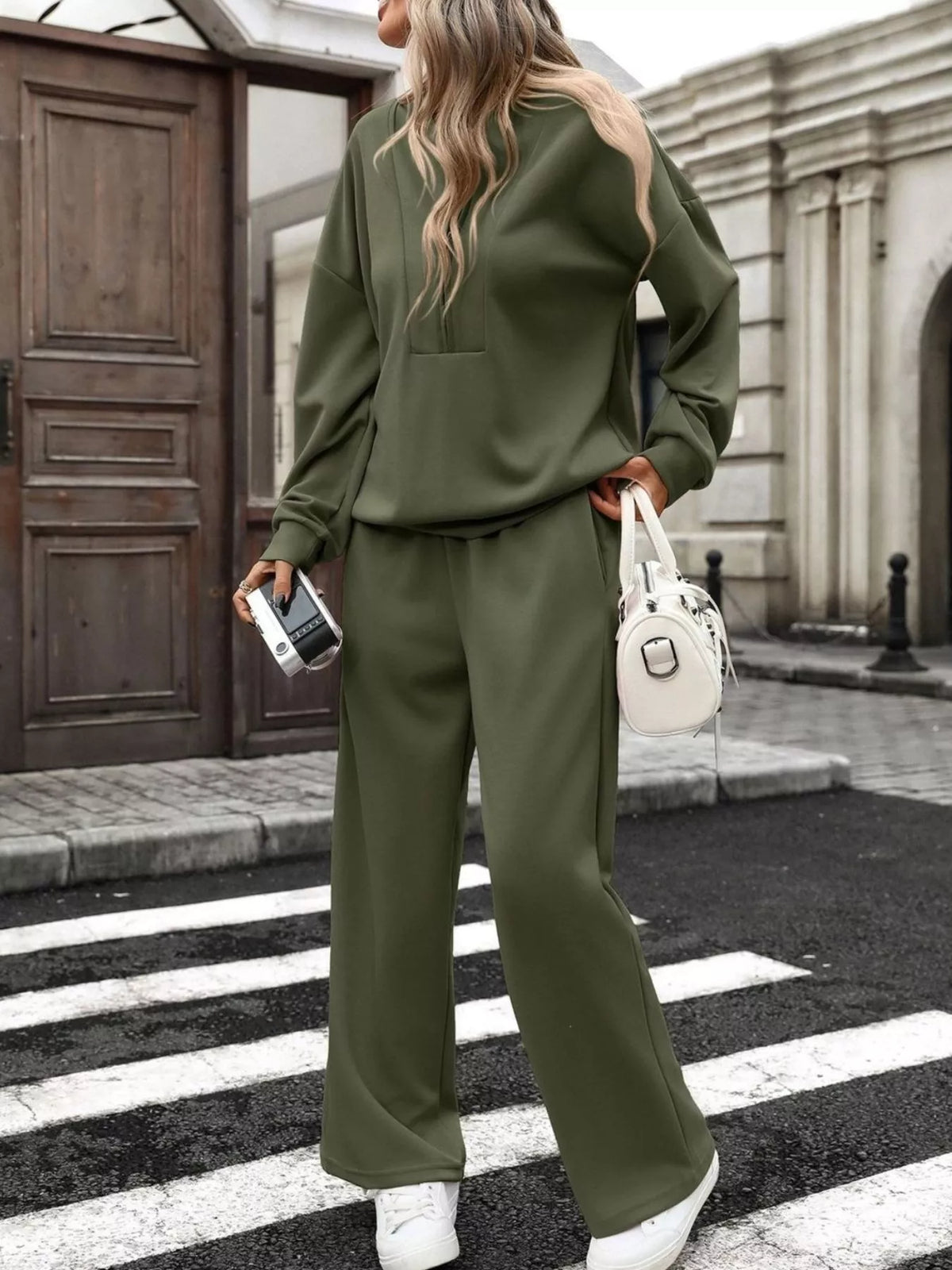 Women’s half zip sweatshirt and wide-leg pants set by Trendsi, featuring a casual, comfortable matching outfit with stylish details.
