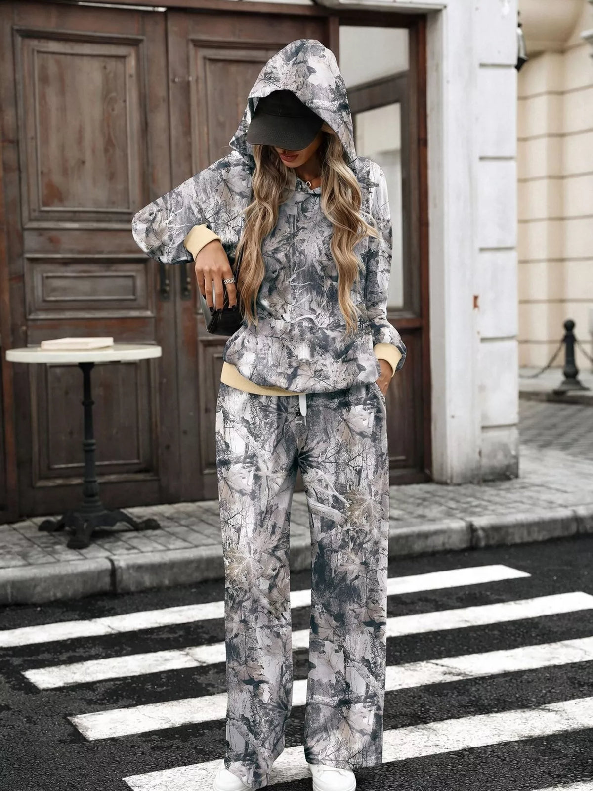 Printed long sleeve hoodie and pants set by Trendsi featuring a stylish design, casual fit, and comfortable fabric.