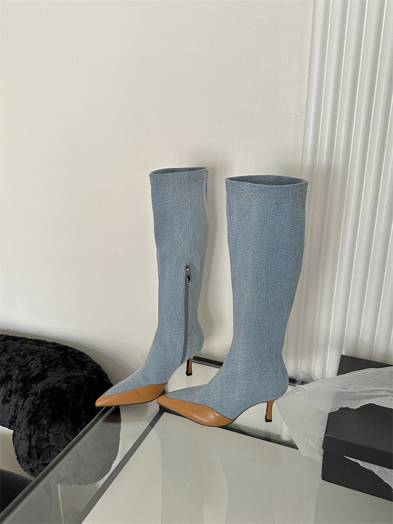 Knee-high denim boots in light blue, featuring tan pointed toes, stiletto heels, and side zippers.