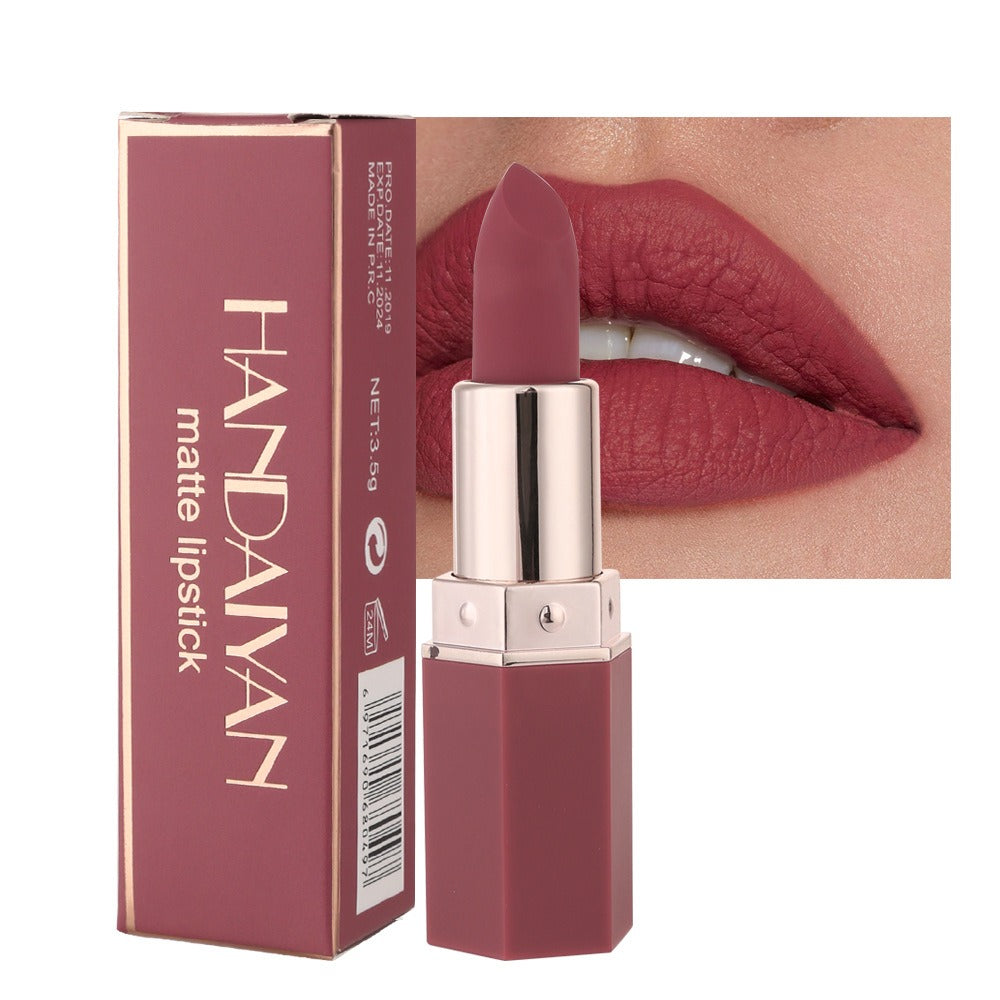 Handaiyan matte lipstick in a mauve pink shade with a hexagonal plastic case beside its matching box.