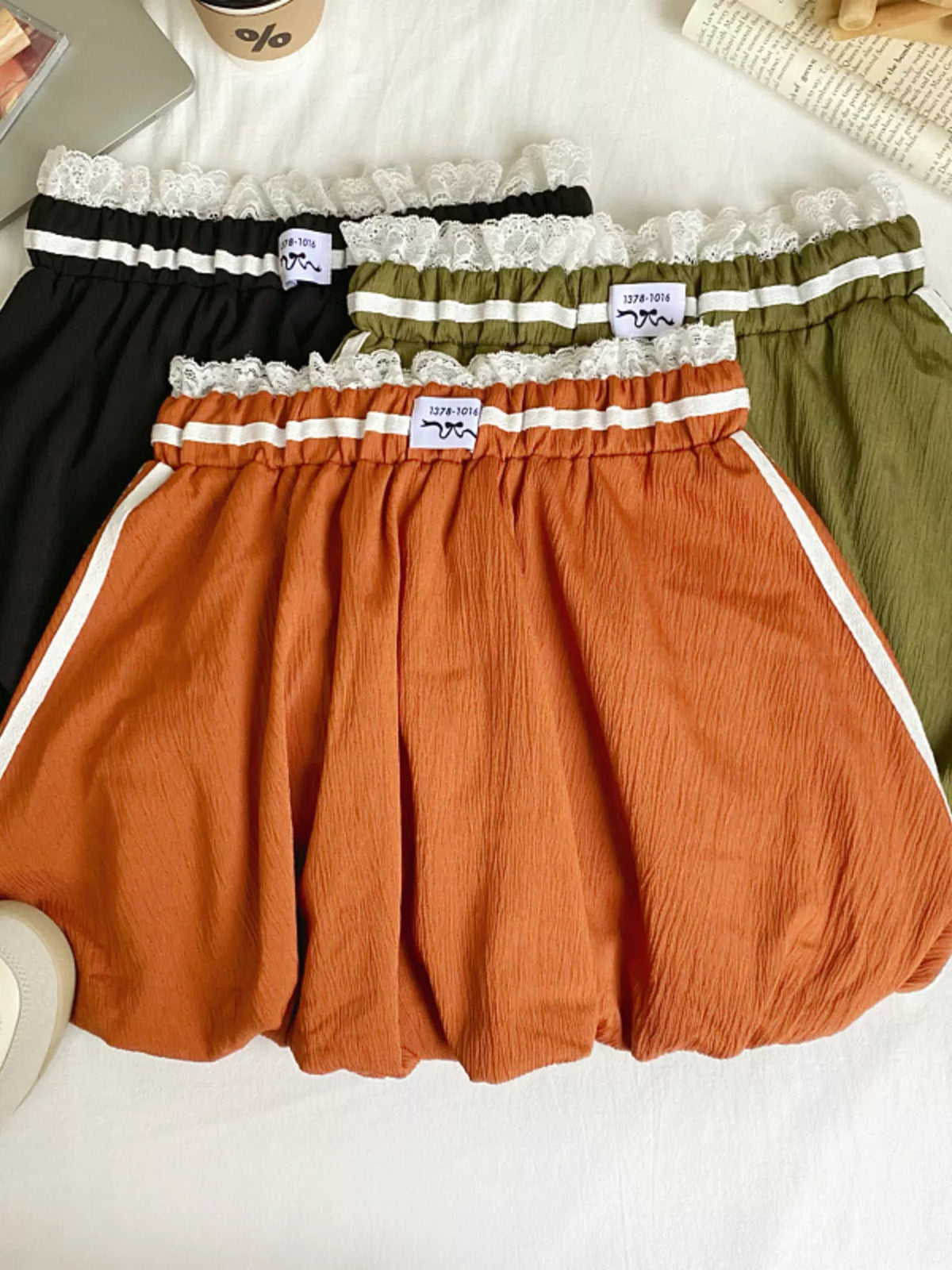 Lace trim elastic waist mini skirt from Plush Fashion Hub featuring a stylish, fitted design with delicate lace details.