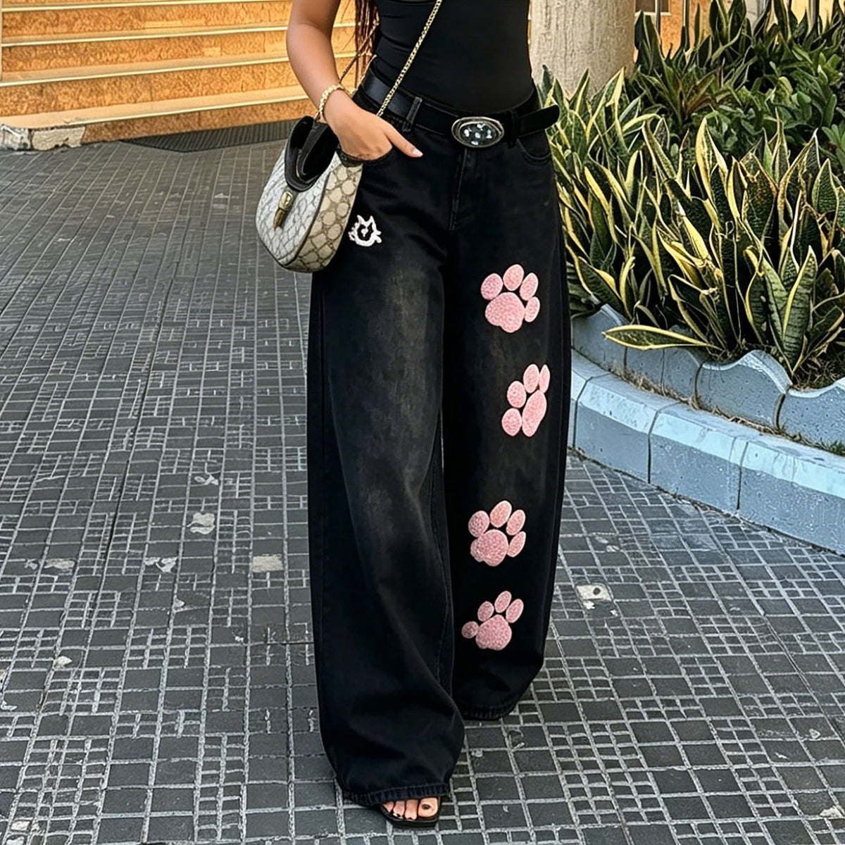 Light blue wide leg jeans with embroidered cat paw design on the back pockets, from Plush Fashion Hub.