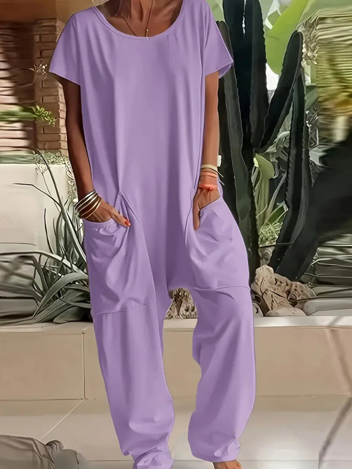 Plus size loose fit V-neck short sleeve wide leg jumpsuit by Trendsi, shown in a relaxed fit with flowing fabric and casual style.