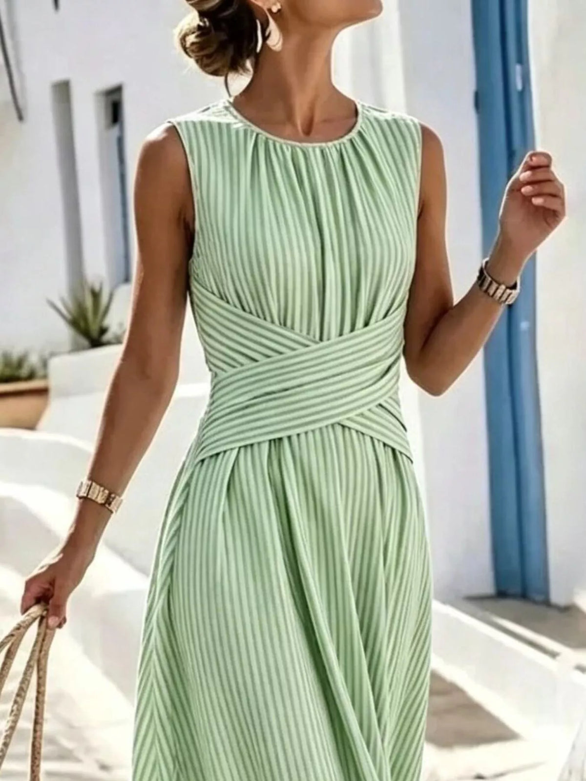Plus size striped sleeveless maxi dress by Trendsi, featuring a full-length design with vibrant horizontal stripes.