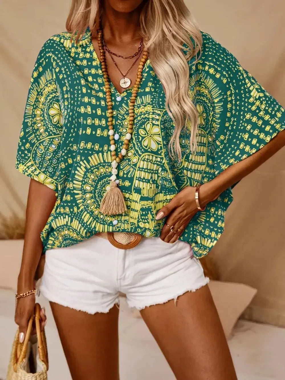 Women's printed V-neck half sleeve casual blouse by Plush Fashion Hub, soft stretch fabric, suitable for office and everyday wear.