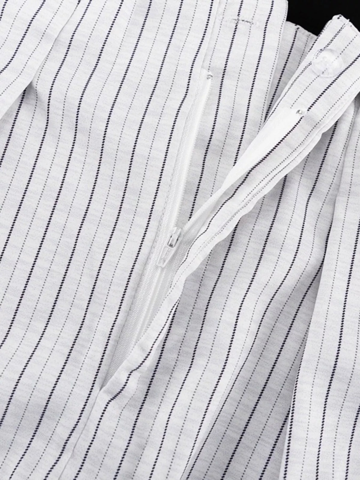 Pinstripe cropped blazer and pleated shorts set by Trendsi, featuring a stylish, coordinated fashion ensemble with tailored fit and pattern detail.