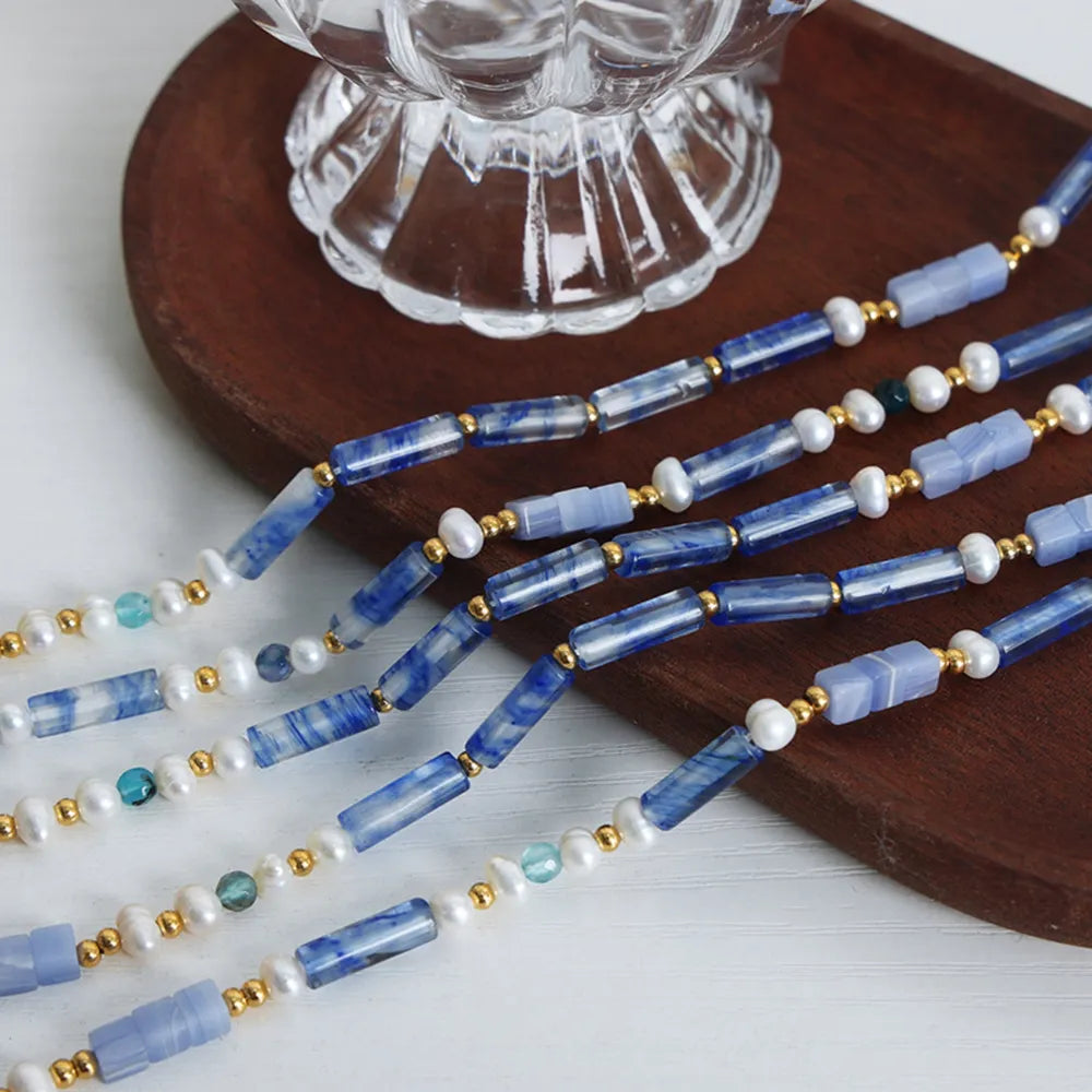 Freshwater pearl and titanium steel geometric bead necklace featuring modern design, crafted by Plush Fashion Hub.