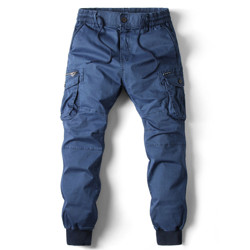 Solid blue cotton cargo pants with drawstring waist, zipper pockets, and ribbed cuffs.