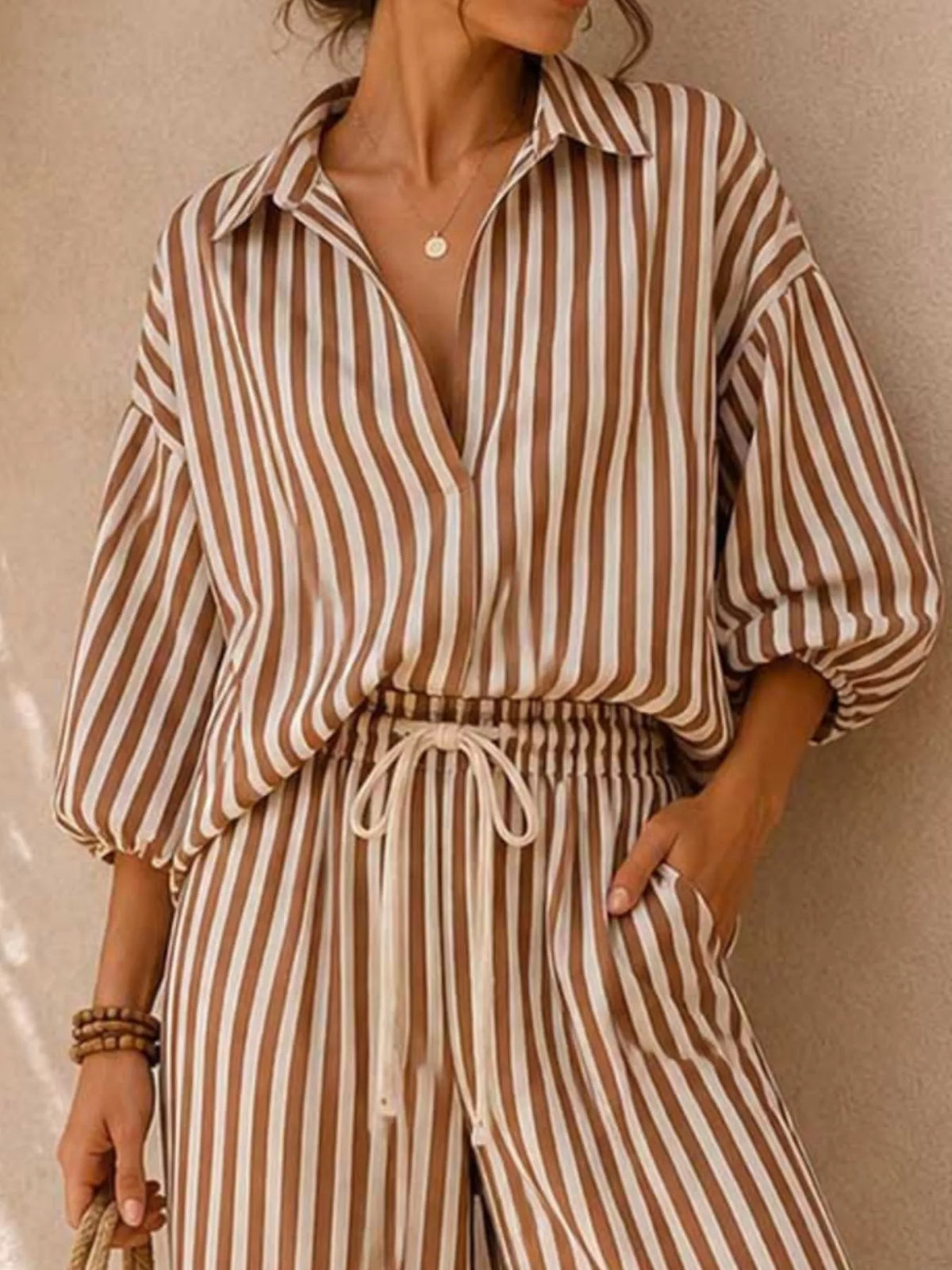 Plus size striped puff sleeve shirt and wide-leg drawstring pants set by Trendsi, featuring a coordinated matching outfit.