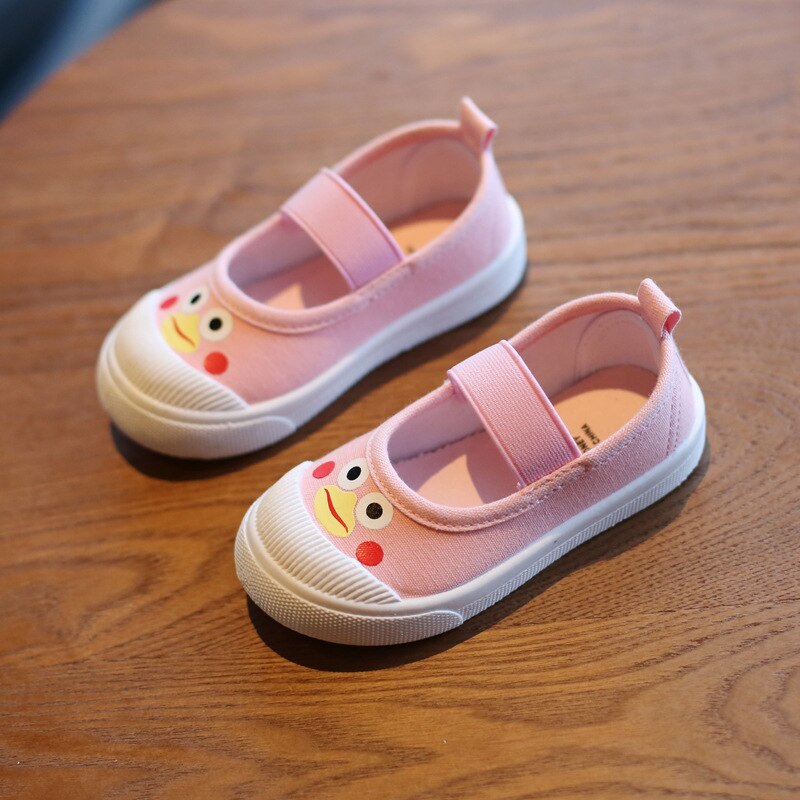 Pink canvas children's Mary Jane shoes with white rubber soles, elastic straps, and cartoon duck faces.