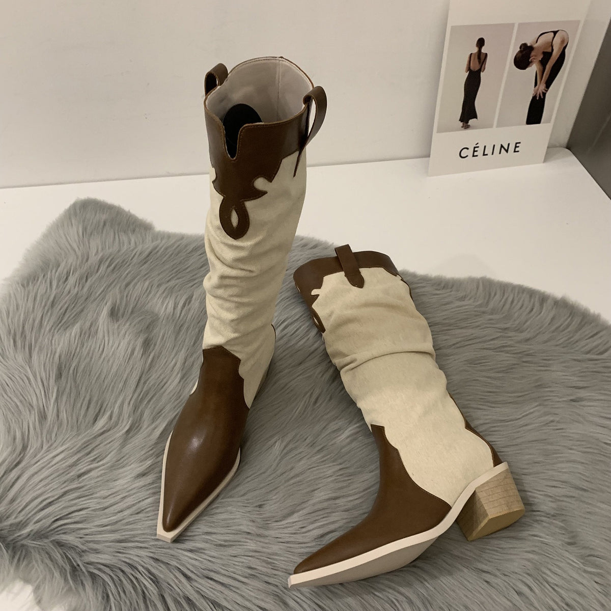 Brown and cream canvas cowboy boots with pointed toes, block heels, and pull tabs.