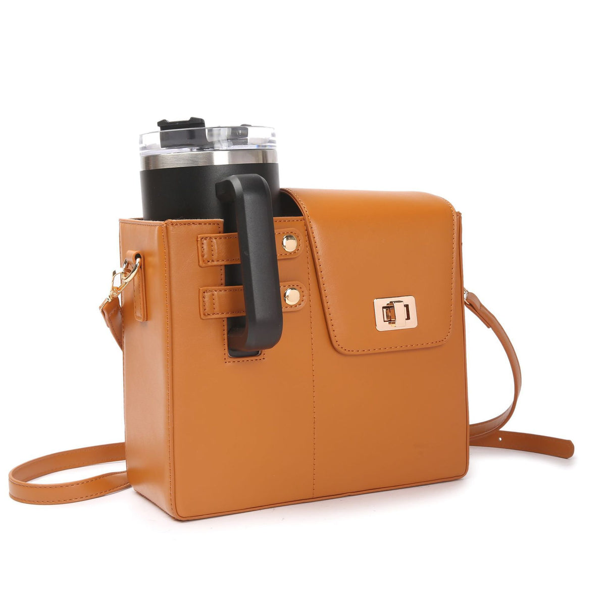 Tan faux leather crossbody bag with a front flap and a built-in cup holder carrying a black travel mug.