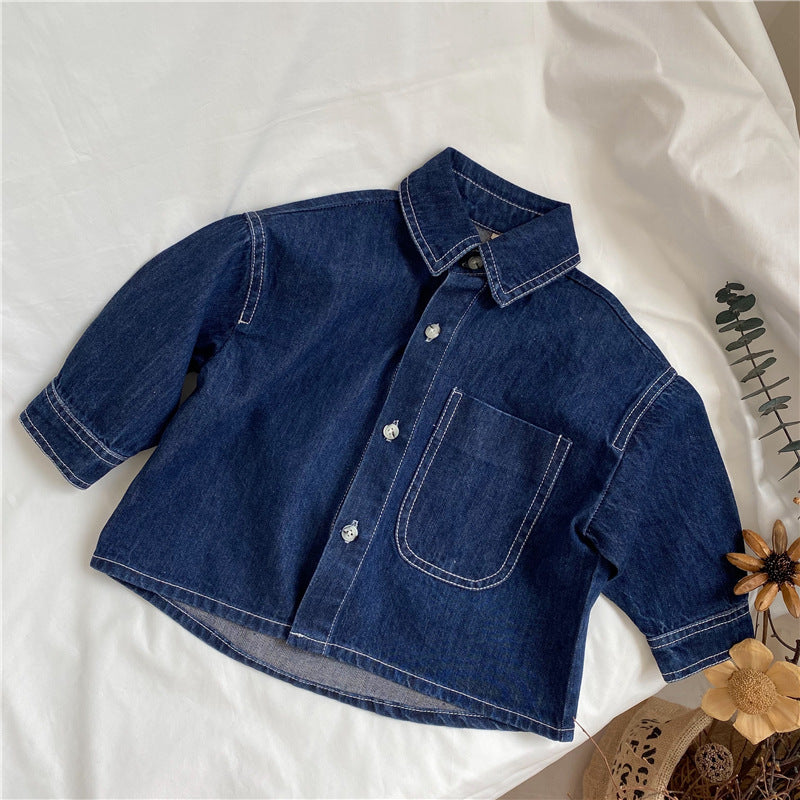 Dark blue denim button-up shirt with white stitching, long sleeves, a collar, and chest pocket.