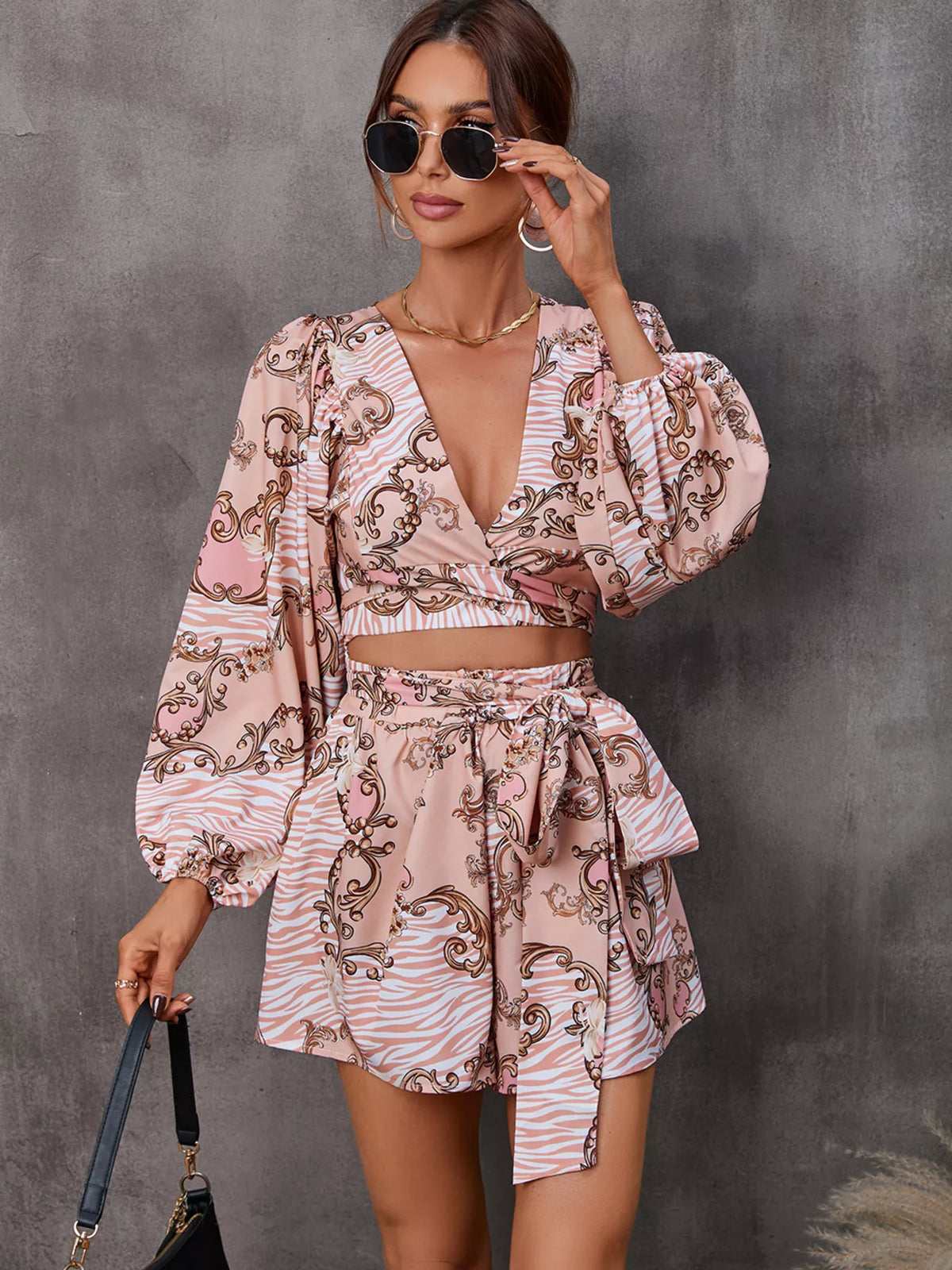 Printed long sleeve romper with front cutout by Plush Fashion Hub, stylish jumpsuit featuring bold design and comfortable fit.