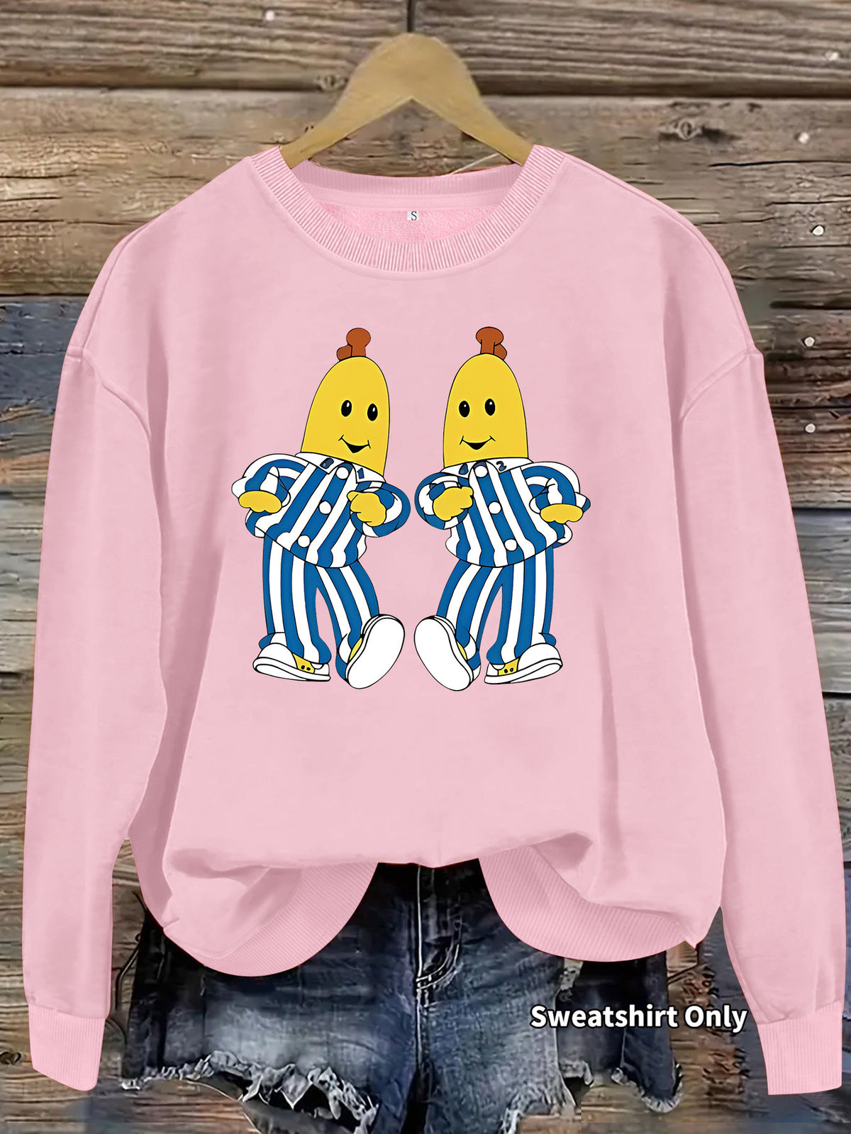 Pink crewneck sweatshirt featuring a graphic of the Bananas in Pyjamas characters.