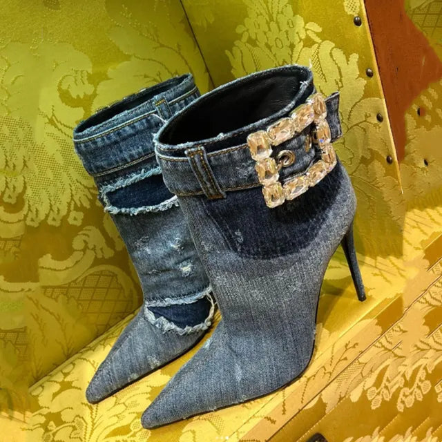 Blue denim stiletto ankle boots with frayed details and a rhinestone-embellished buckle strap.