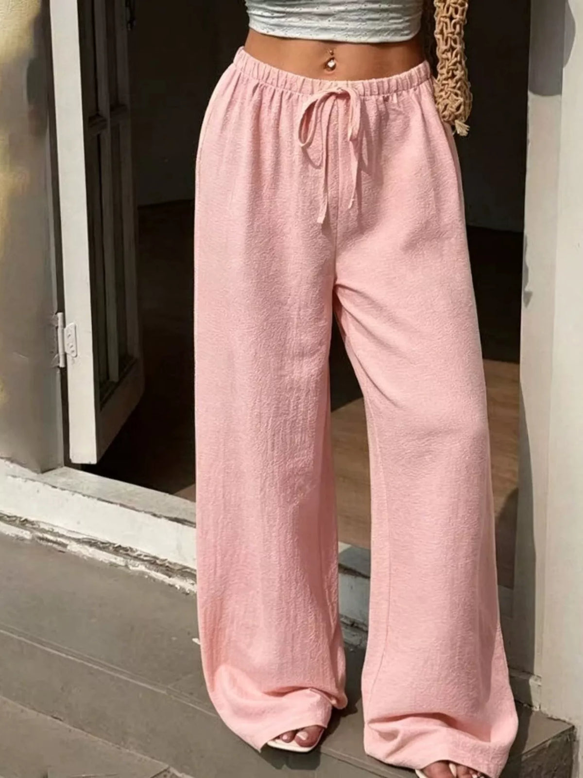 Plus size high-waisted wide-leg pants by Plush Fashion Hub, featuring flowing fabric and a comfortable fit.