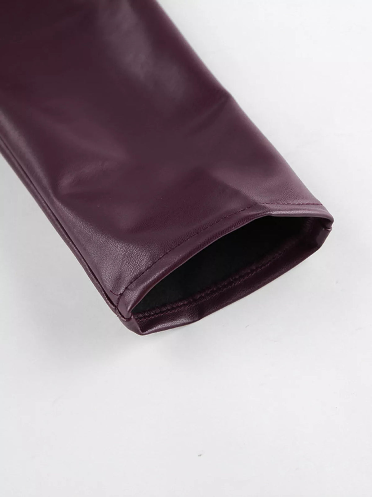 Women's faux leather jacket with stand collar and belt from Trendsi, featuring a stylish design and sleek black finish.