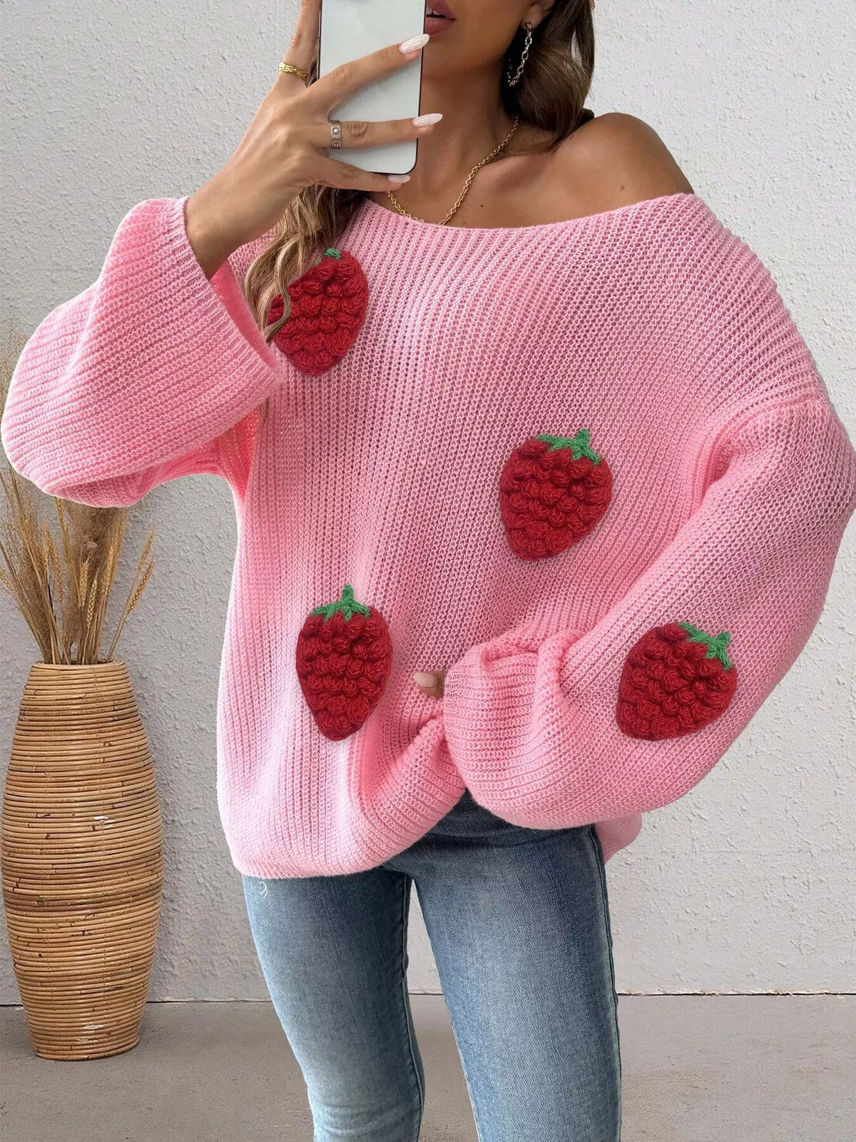 Oversized strawberry applique sweater from Trendsi featuring a cozy knit design and playful strawberry detail.