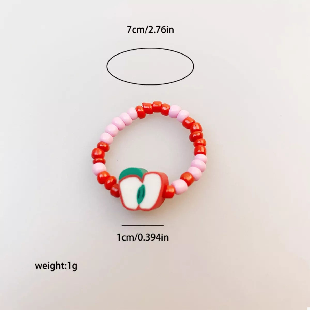 Colorful fruit beaded ring from Plush Fashion Hub featuring vibrant fruit charms and multicolored beads on a silver band.