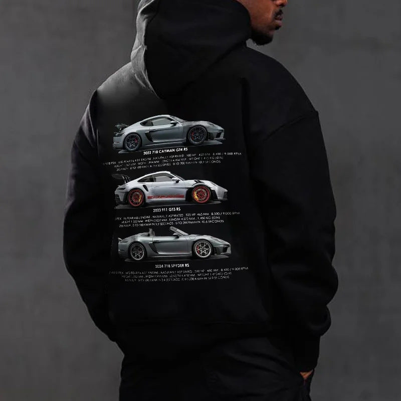 A man wearing a black long-sleeve hoodie featuring three stacked silver sports car graphics on the back.