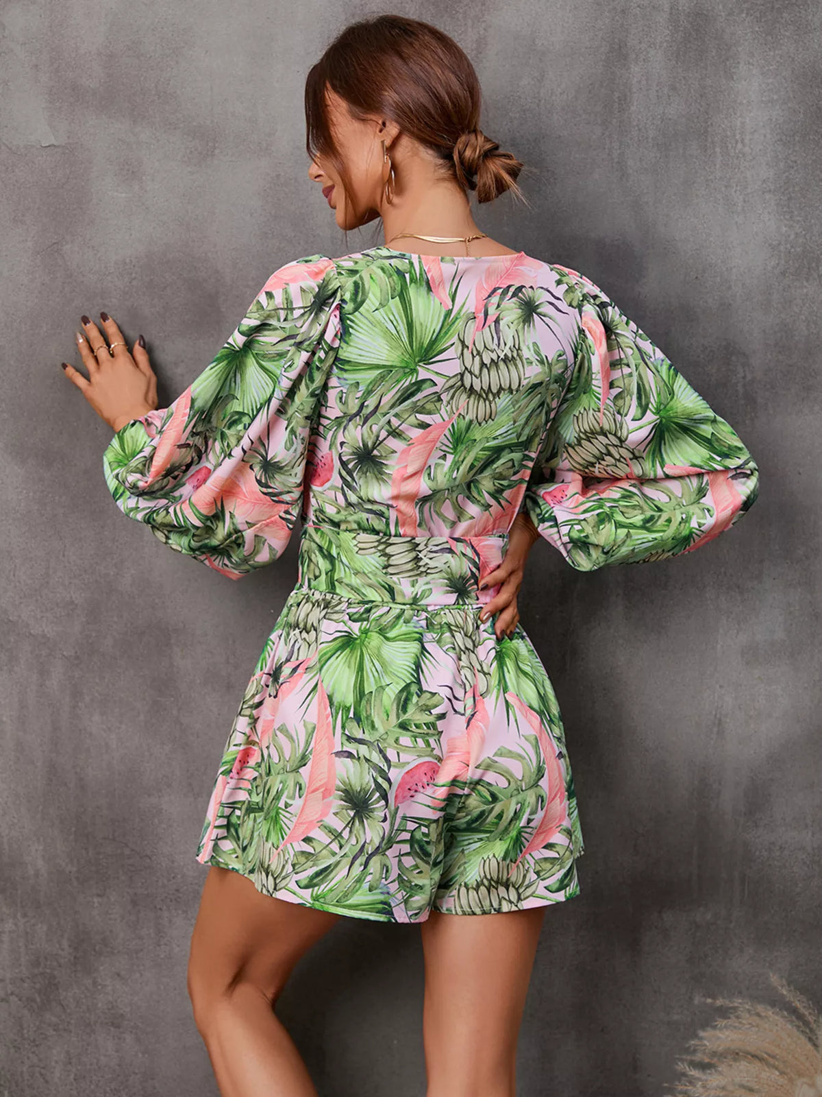 Printed long sleeve romper with cutout front, stylish jumpsuit by Plush Fashion Hub, shown in a vibrant, patterned design.