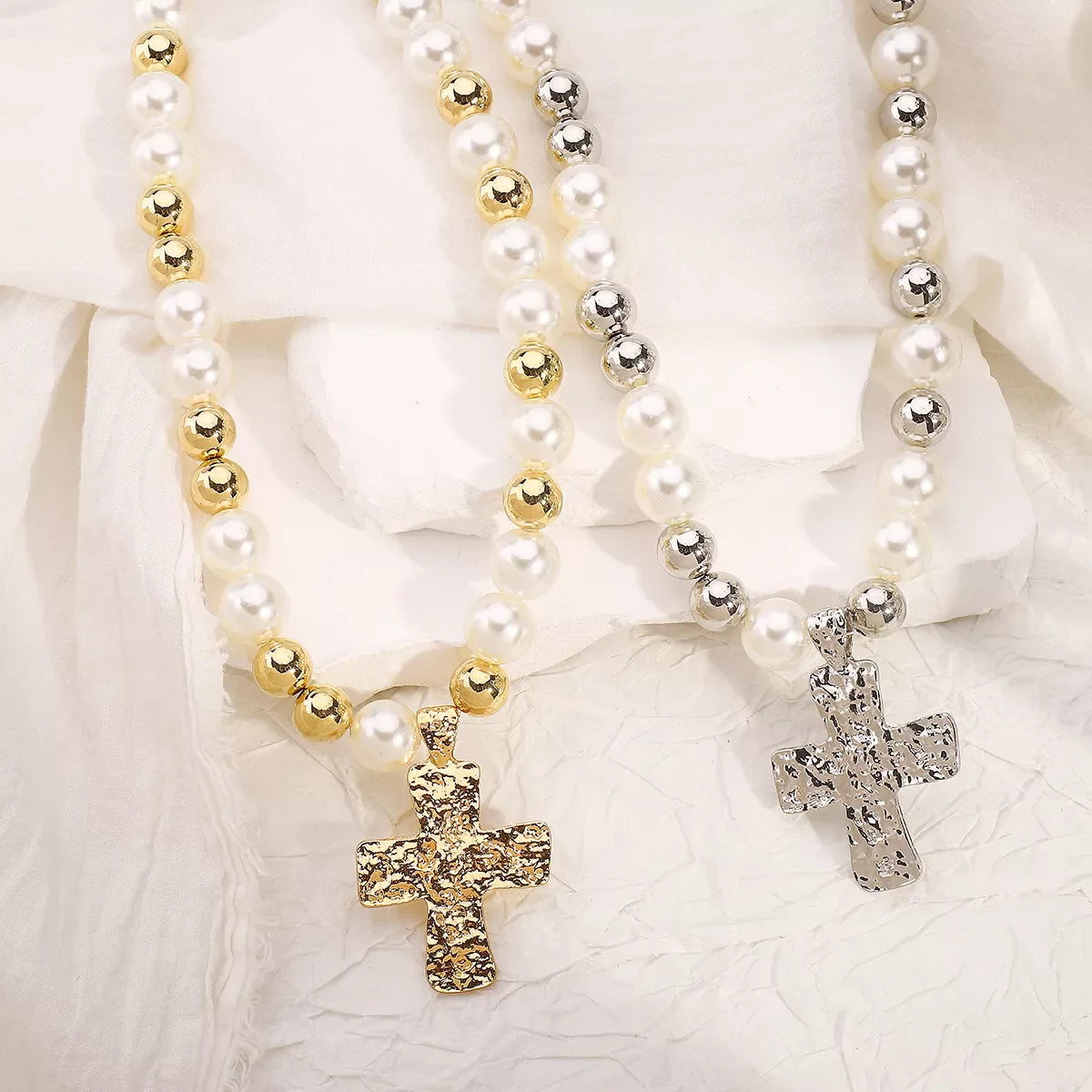 Pearl and cross pendant necklace from Plush Fashion Hub featuring a elegant jewelry design with white pearls and a silver cross.