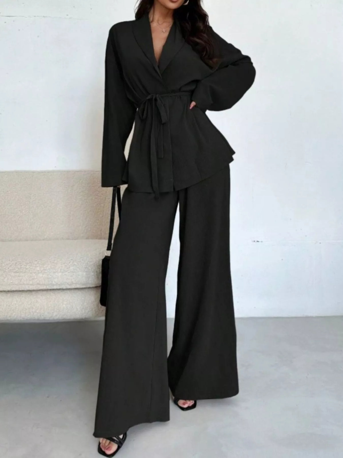 Textured tie waist top and wide-leg pants set for women by Trendsi, featuring a stylish, coordinated look in a comfortable fabric.