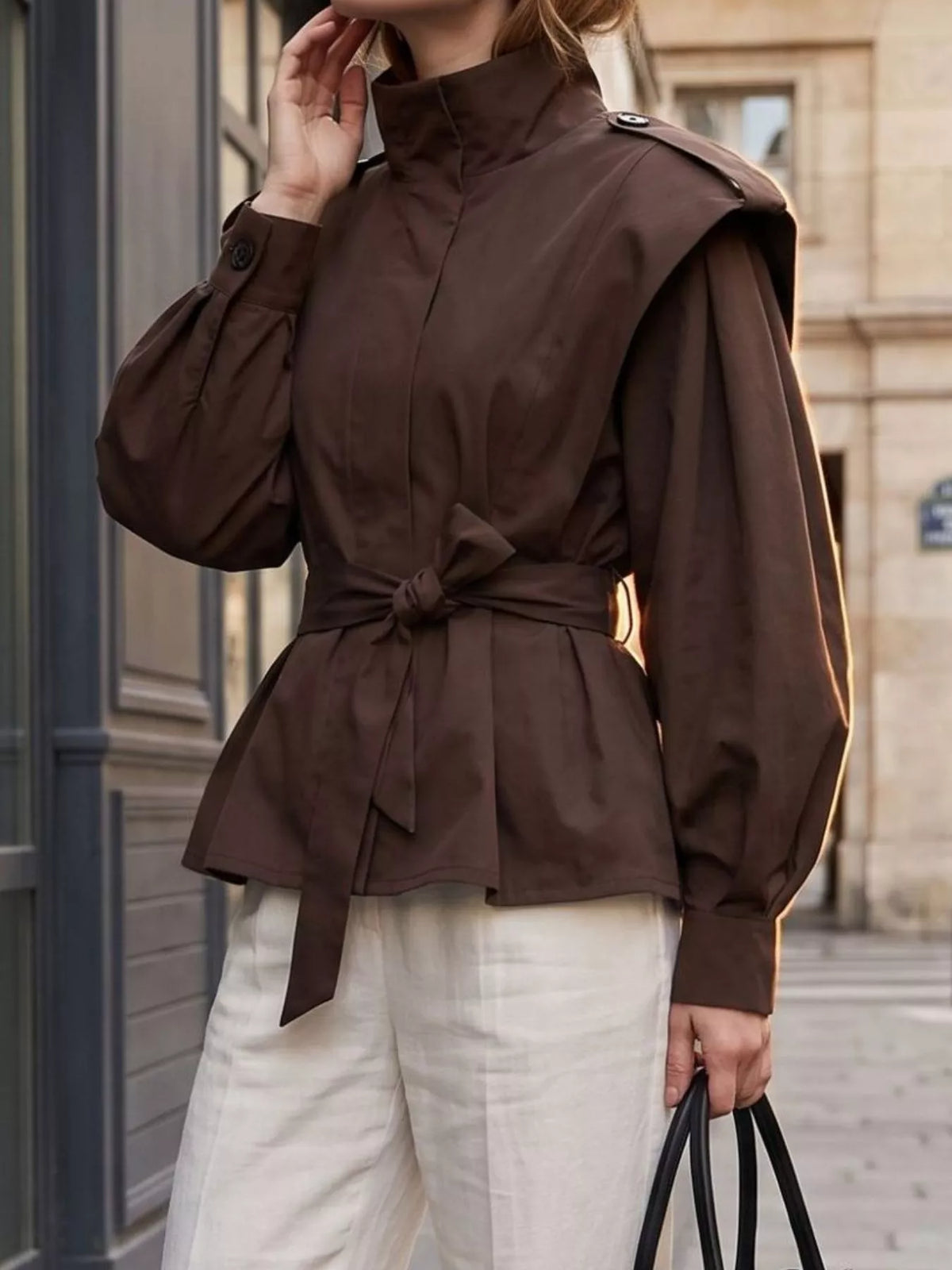 Trendsi stand-collar belted outerwear jacket with front pockets, stylish design, and adjustable belt for a chic, modern look.