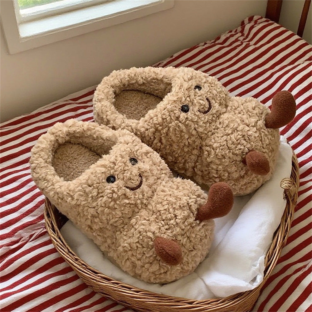 Beige fuzzy plush slippers with embroidered smiley faces and brown paw details in a woven basket.