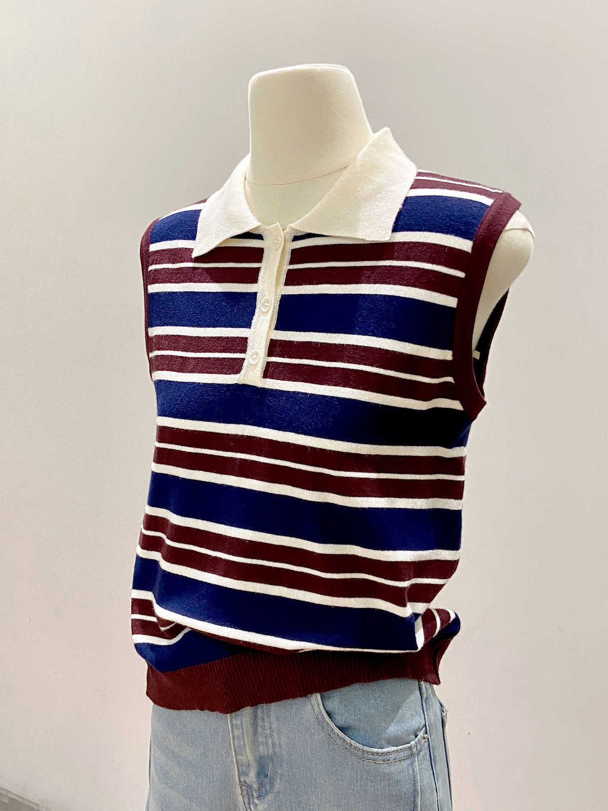 Color-blocked stripe knit vest for women by eprolo, featuring vibrant color panels and a sleeveless design.