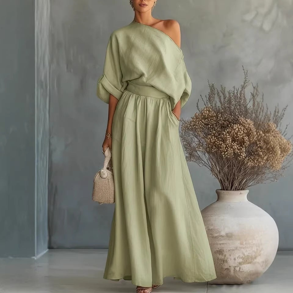 Elegant plush fashion hub fitted asymmetrical shoulder top and matching pants two-piece outfit, stylish and modern ensemble.