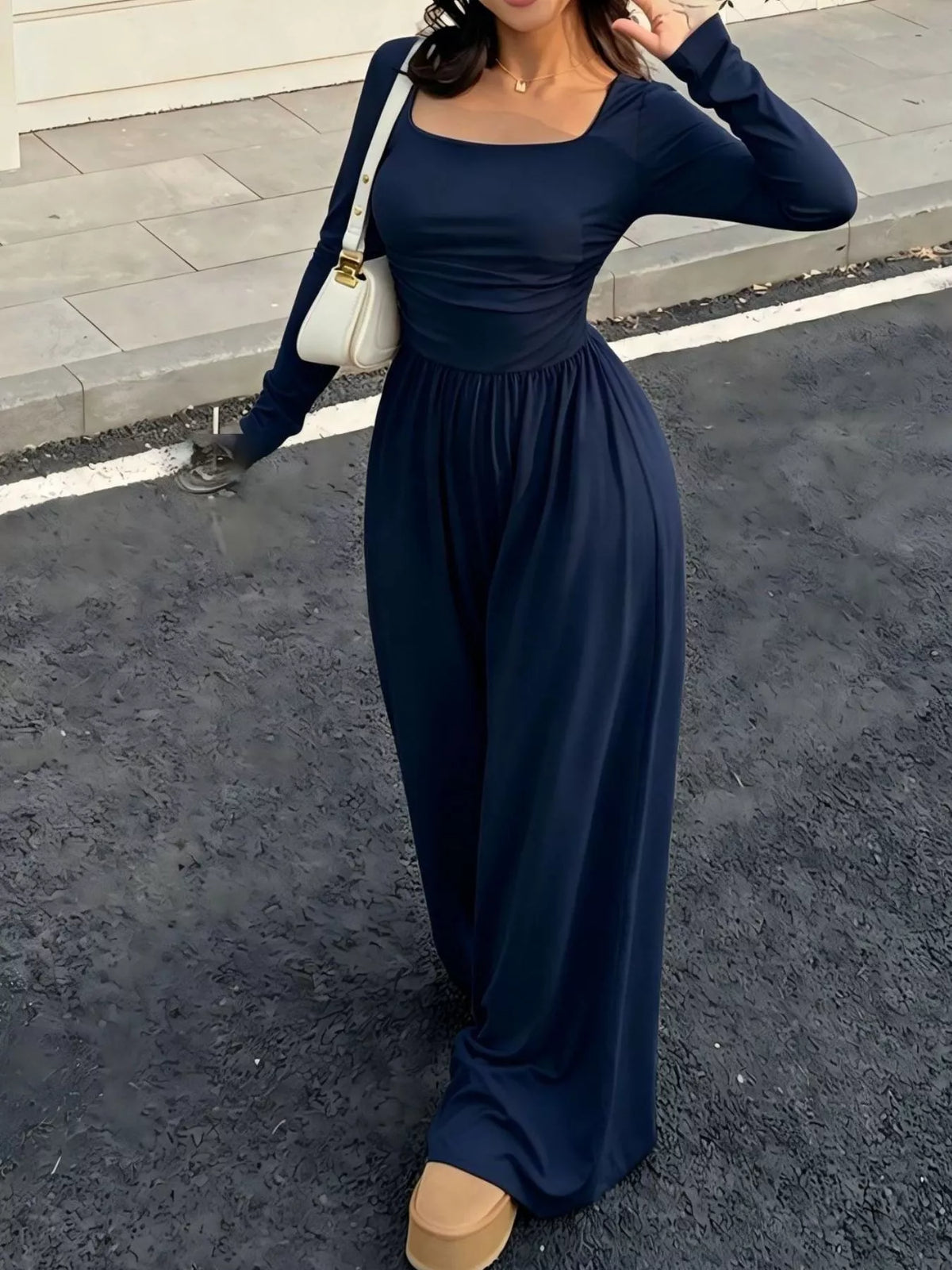 Black ruched square neck wide-leg jumpsuit by Trendsi, featuring a fitted bodice and flowing wide-leg pants.