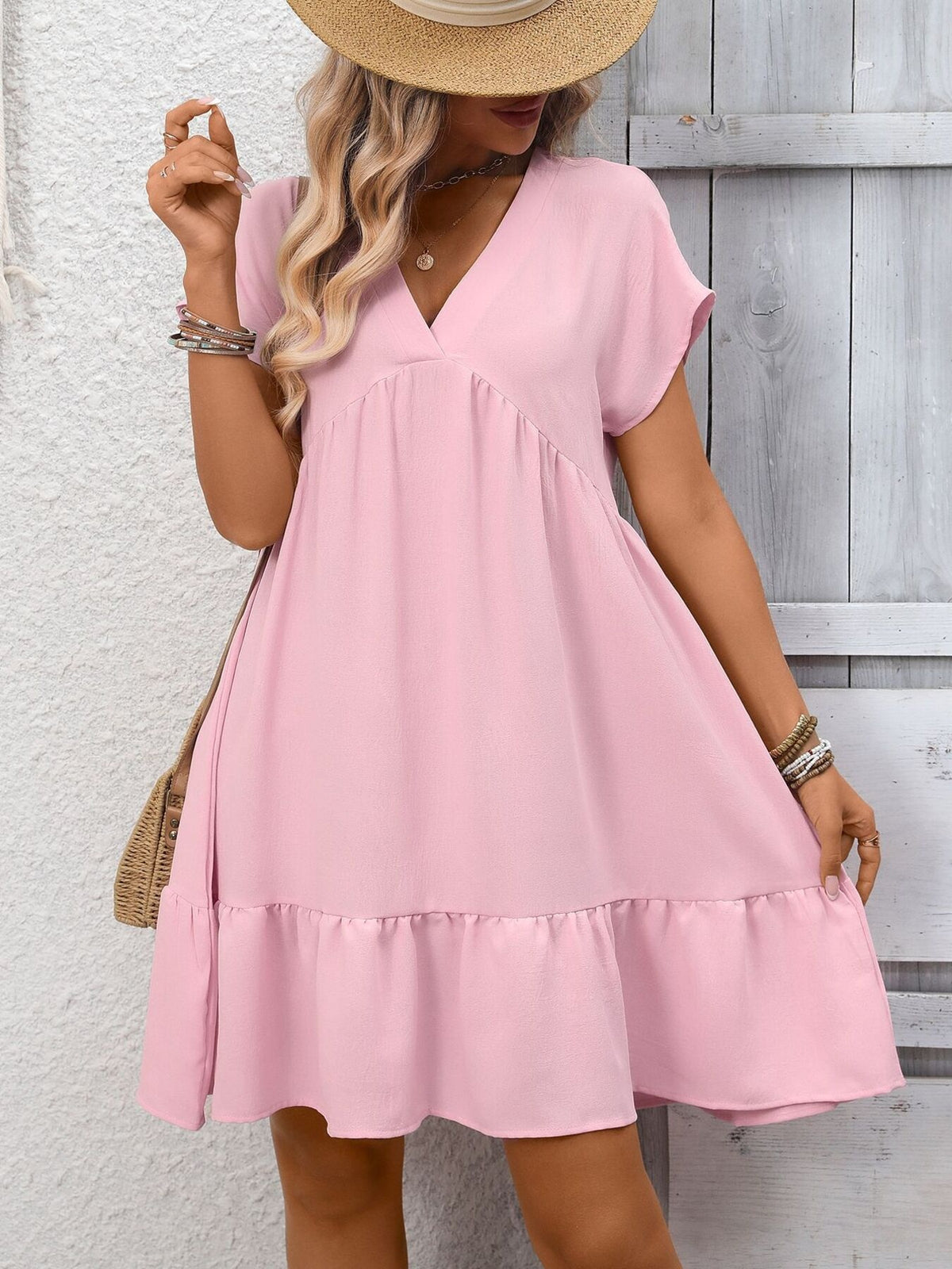 Women's V-neck ruffle hem mini dress with ruched details by Plush Fashion Hub, featuring a stylish and flattering design.